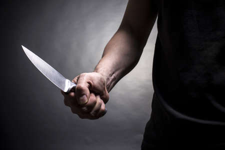 17955069 the man with a knife in a hand closeup