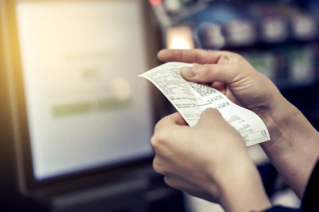 girl looks receipt store scaled 1